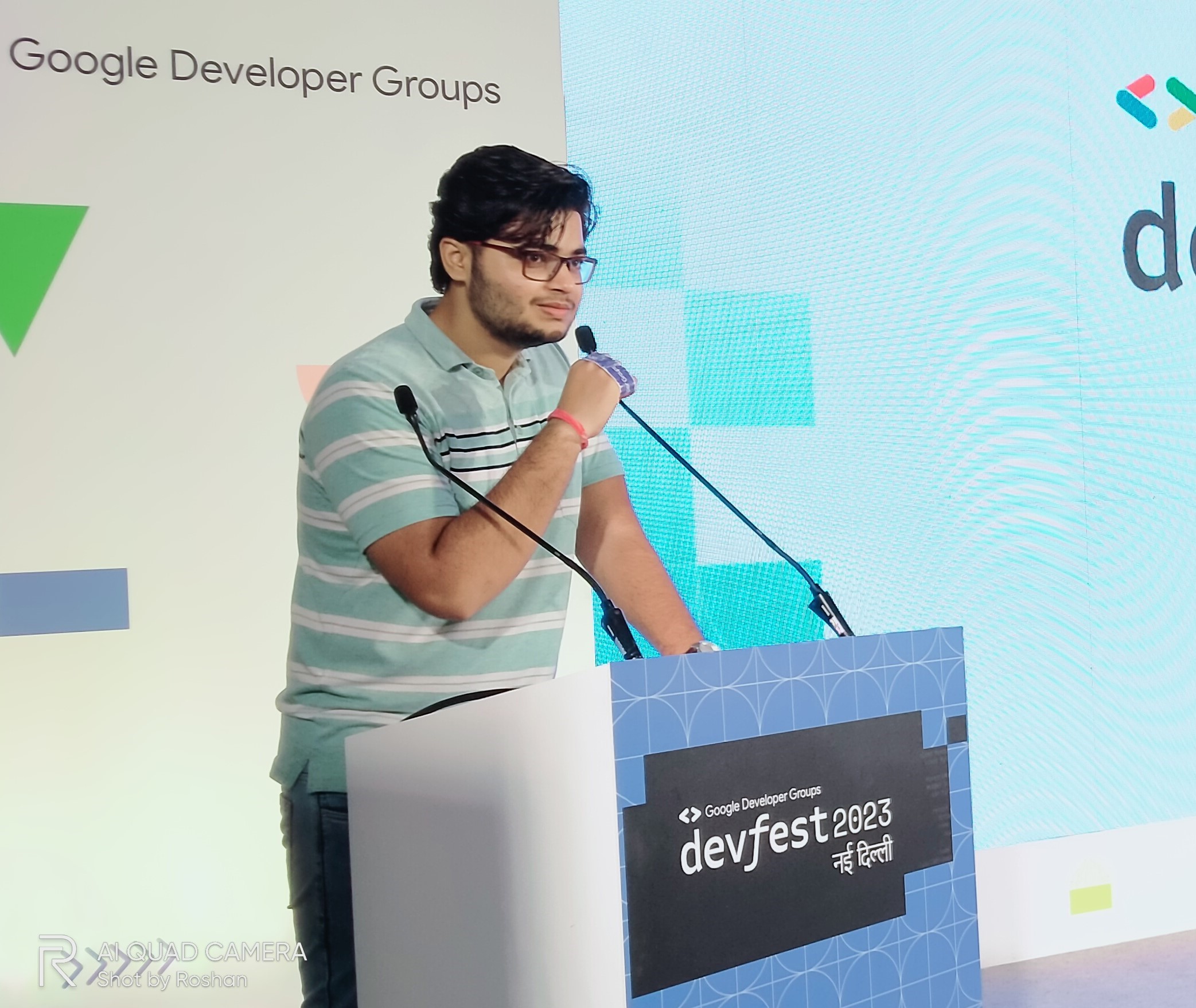 Chirag standing at the podium of devfest new delhi 2023